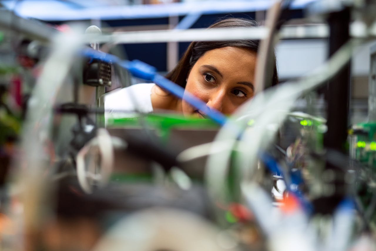 Focused female engineer analyzing equipment at a modern lab.